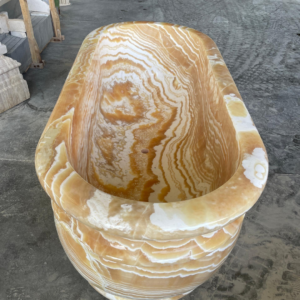 luxury orange onyx bath tub with white veining for luxury project in USA
